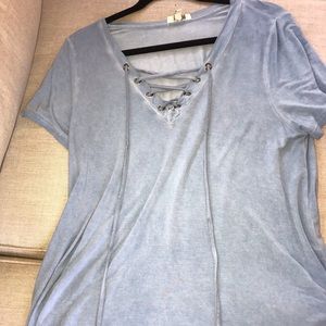 blue t shirt with a cross cross in front